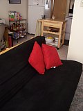 A view of the futon. The kitchen is in the background. 